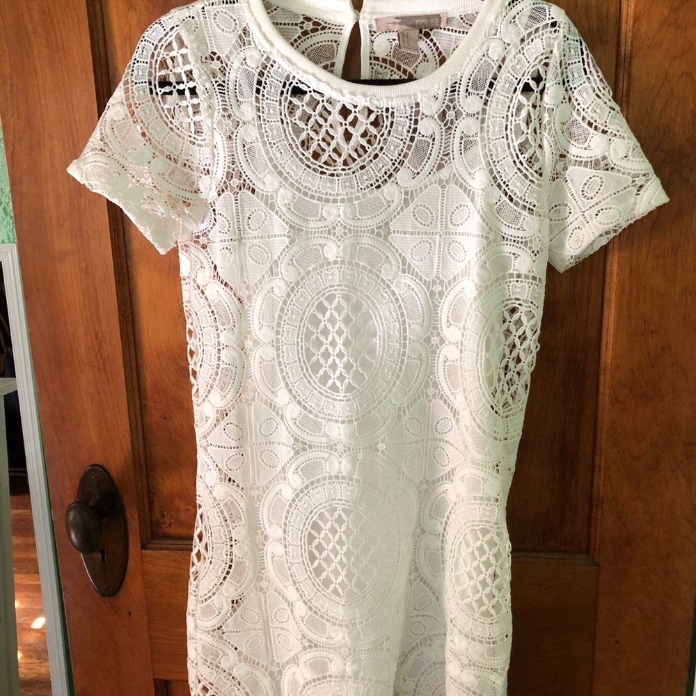 White lace dress with a white slip underneath.
